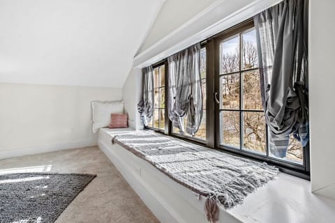 Our fifth bedroom has a King bed, window seat, closet, Smart TV, and en suite bathroom.