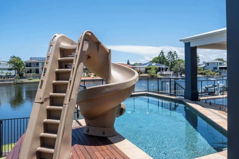 View of pool and slide from behind.
