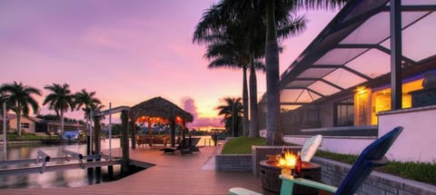 Composite marketing image showcasing the dock, tiki hut, and waterfront setting with a featured guest review overlay