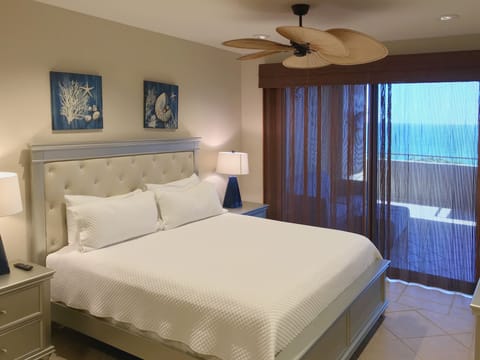 Primary suite with access to private balcony and ocean views