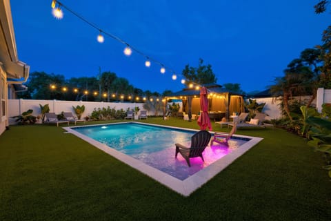 Backyard lit up at night for resort-style vibes