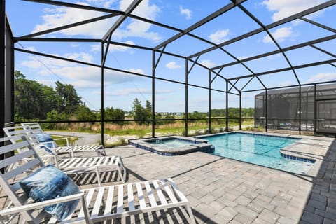 Unwind in this serene outdoor space featuring a private pool and spa. Lounge under the Florida sun with no rear neighbors for ultimate privacy and tranquility.