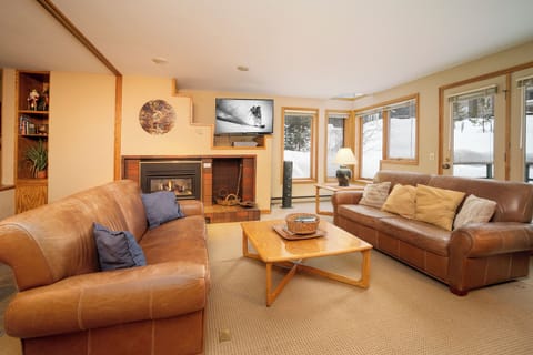 Sink into plush leather sofas by your crackling fireplace, watching snow fall through picture windows in your cozy mountain retreat.