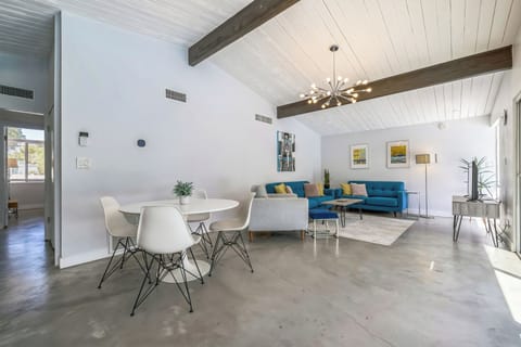 Living room and breakfast area look out to the pool and backyard