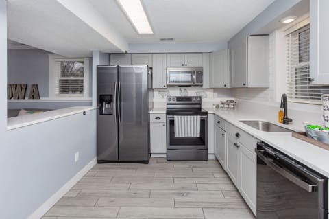 Kitchen with stove, fridge, dish washer, utensils, and dishes for a comfy stay