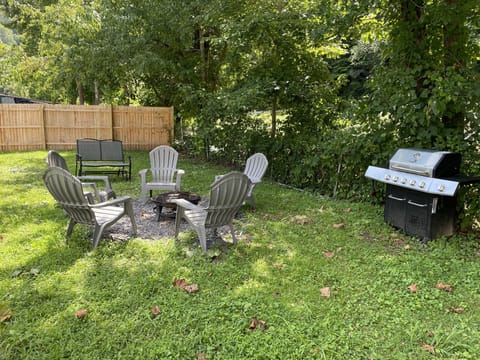Private back yard with gas grill, fire pit with firewood included and glider.  