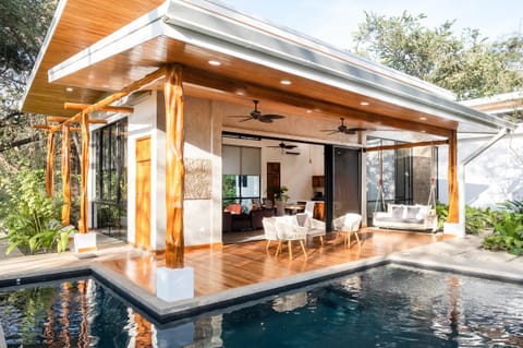 Beautiful terrace with swing by pool.
