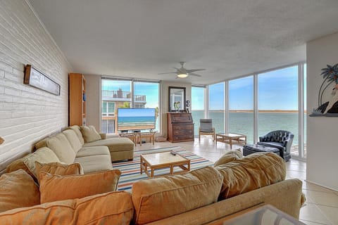 Relax in your expansive living room with stunning ocean views through floor-to-ceiling windows. Sink into comfortable seating while enjoying breathtaking water vistas.