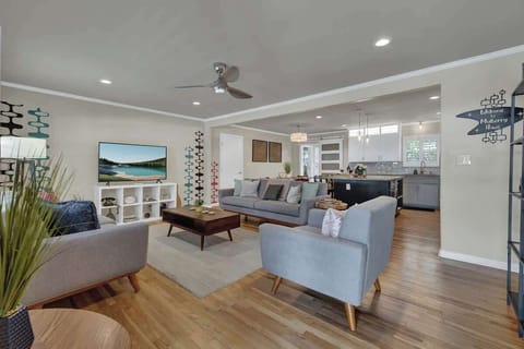 The open floor plan creates a seamless flow between the kitchen, dining, and living areas, making it easy to gather and connect with friends and family.