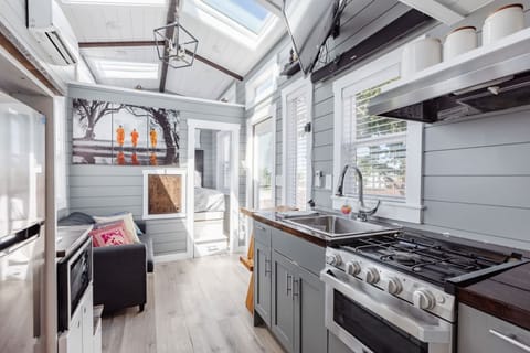 Kitchen fully equipped with a refrigerator, freezer, microwave, stove, oven and sink with hot/cold water. Enjoy coffee from the coffee maker and ample counter space. Essentials include cookware, dishes, utensils, and plenty of storage cabinets.