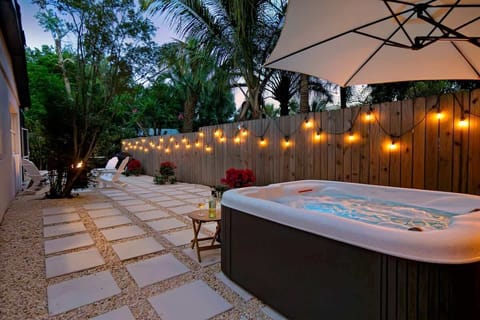 Enjoy the freestanding hot tub in this West Palm Beach, Florida retreat, complete with an umbrella to keep you sheltered from sun or rain the perfect spot to unwind in any weather.
