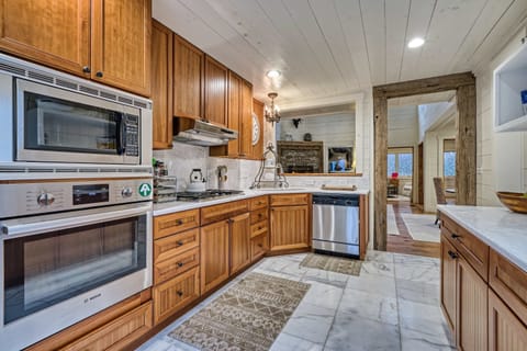 Modern kitchen with stainless steel appliances and warm wood cabinetry