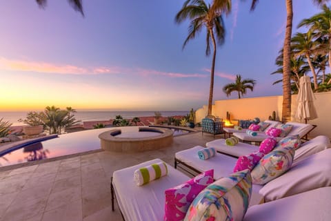 A view from the lounge chairs of the ocean at sunset.