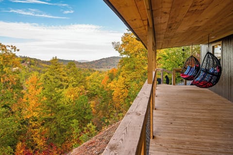 Picture yourself on this covered porch, in the hanging egg chairs, just relaxing