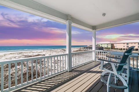 Unwind and rejuvenate in the tranquil master suite on the private balcony with breathtaking panoramic ocean views, overlooking the pristine white sand beaches of Gulf Shores