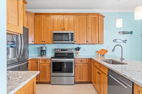 full kitchen with bar seating and dining area
