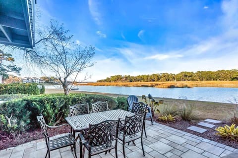 Picture yourself dining al fresco on your private patio, where every meal becomes a peaceful retreat overlooking serene marshlands and shimmering waters.