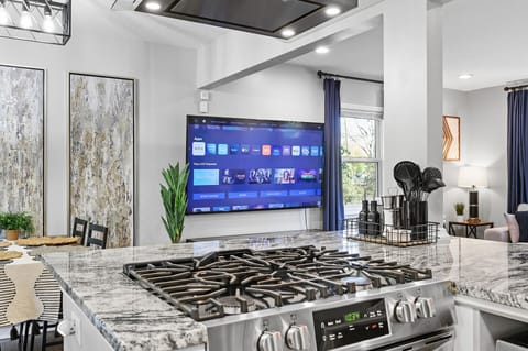 Gas stove top and 70" TV to living room.
