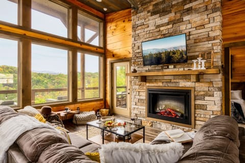Get cozy and enjoy the fireplace on the oversize couch with pillows and throws
