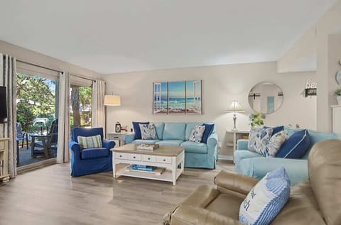 Sink into coastal comfort in your bright living room, where ocean-themed blues and nautical accents create the perfect seaside retreat.