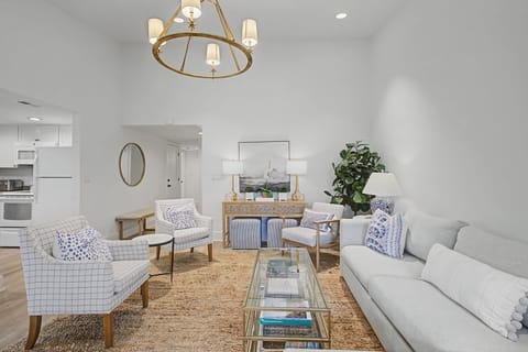 Sink into plush seating surrounded by designer touches and warm natural light in this elegant living space.