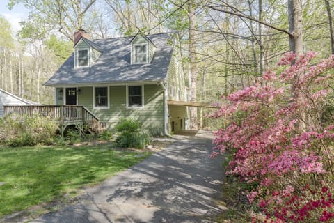 An exterior shot of Flat Creek Cottage, showcasing its charming architecture and integration with the natural landscape.