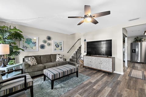 Carefree living room with stairs leading to 3 upstairs bedrooms and bath 