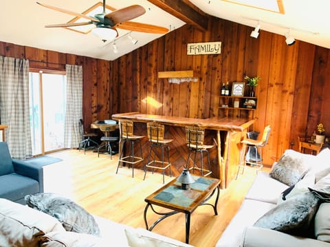 Spacious living room with a large bar for entertaining! 
