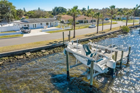 1830 Riverside Drive E is the blue house with boat dock and lift