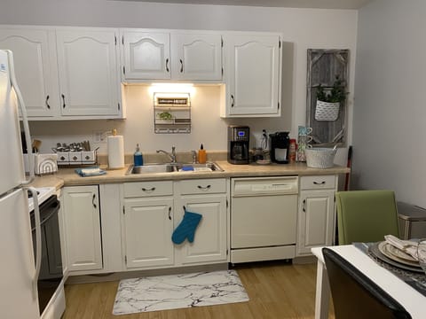 Full operational kitchen with dishwasher, full size refrigerator.