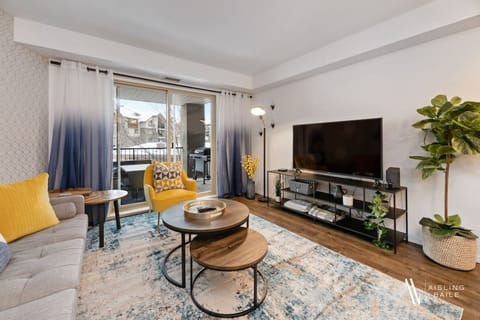 Living room with a Smart TV, high-speed WiFi, cozy couch and walkout access to the private balcony.