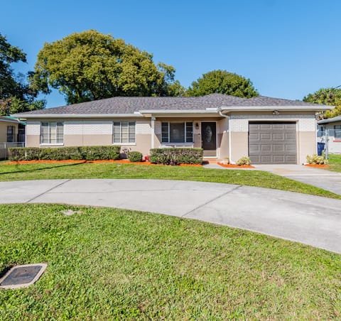 Well manicured spacious home yard with circular drive in peaceful neighborhood