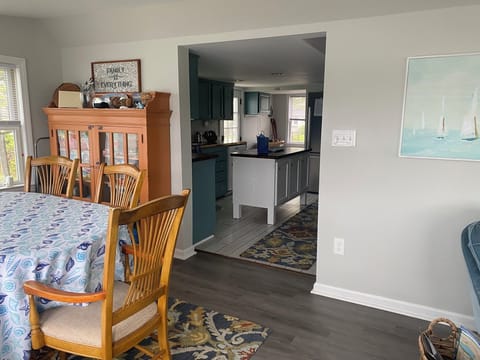 View to the stairs and kitchen from the dining room.