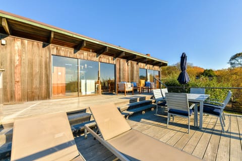 Expansive sun deck with dining set, loungers, and seating area.