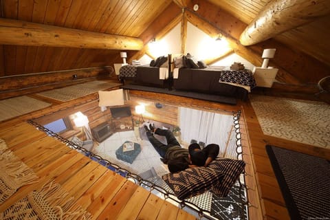This loft features twin beds and a hammock netting area, perfect for lounging or sleeping. 