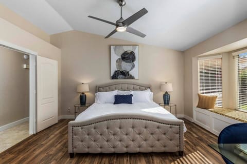 Luxurious master bedroom with King bed, fine linens, smart TV, and work space.