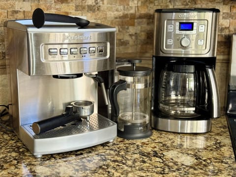 Enjoy the coffee bar featuring an espresso machine, coffee pot, & French press.