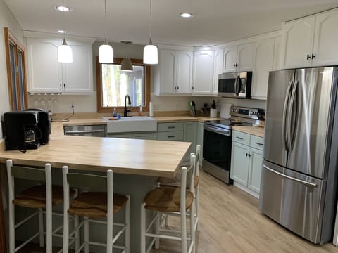 Kitchen with dishes, pots, pans, utensils and basic supplies.