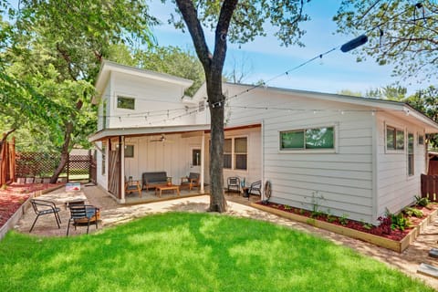 Fully fenced in yard with grassy area, fire pit and back patio