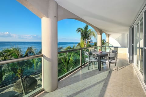 Sip your morning coffee on this stunning oceanfront balcony, where endless blue waters and swaying palms create your perfect tropical escape.