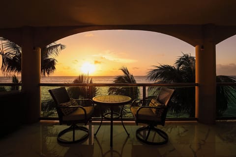 Sip your morning coffee as golden sunrise paints the ocean horizon from your private terrace.