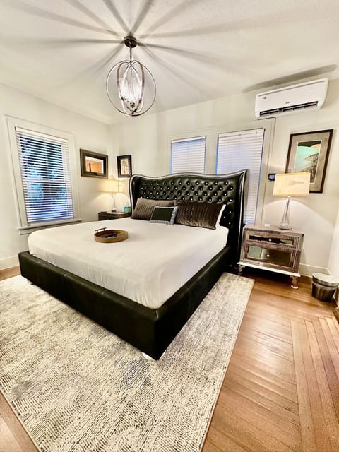 comfy King bed with decorative leather headboard