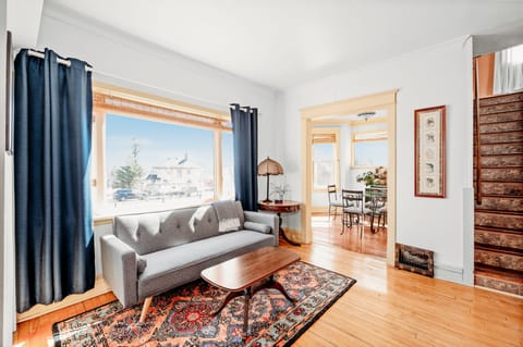 Sun filled living room with two sitting spaces.