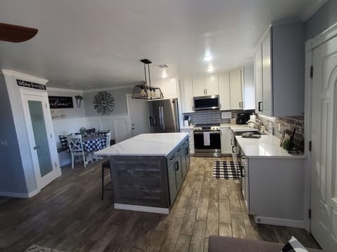 Beautifully updated and well stocked kitchen with stainless steel appliances.