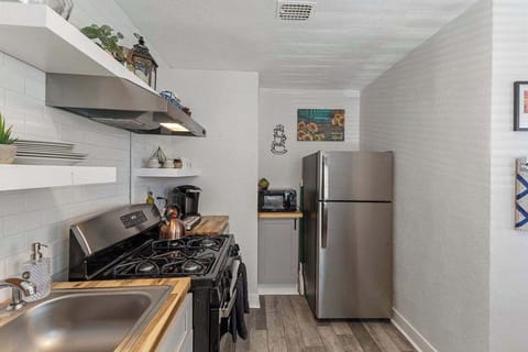 The kitchen also has a microwave and refrigerator.