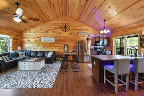 Open-concept rustic living area with a fully equipped kitchen and cozy seating.