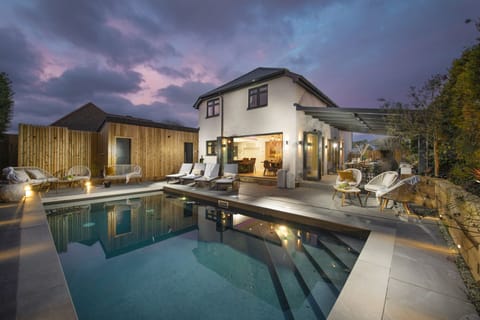 The property all lit up at night and its pool - Chy An Eglos