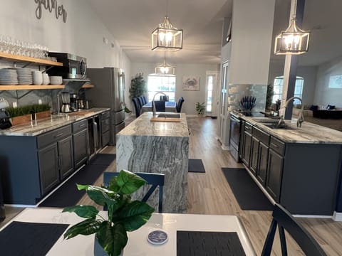 View from breakfast table of fully stocked kitchen. Pots/pans spices, everything