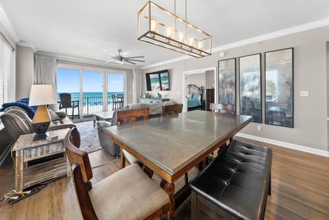 Your spacious open-plan retreat combines dining, living, and kitchen areas with stunning ocean views through floor-to-ceiling windows.