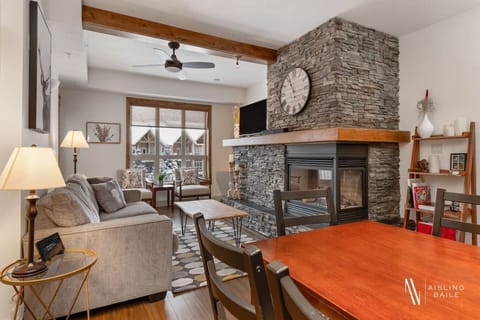 Living room with a gas fireplace, smart TV, pull-out couch& access to the patio